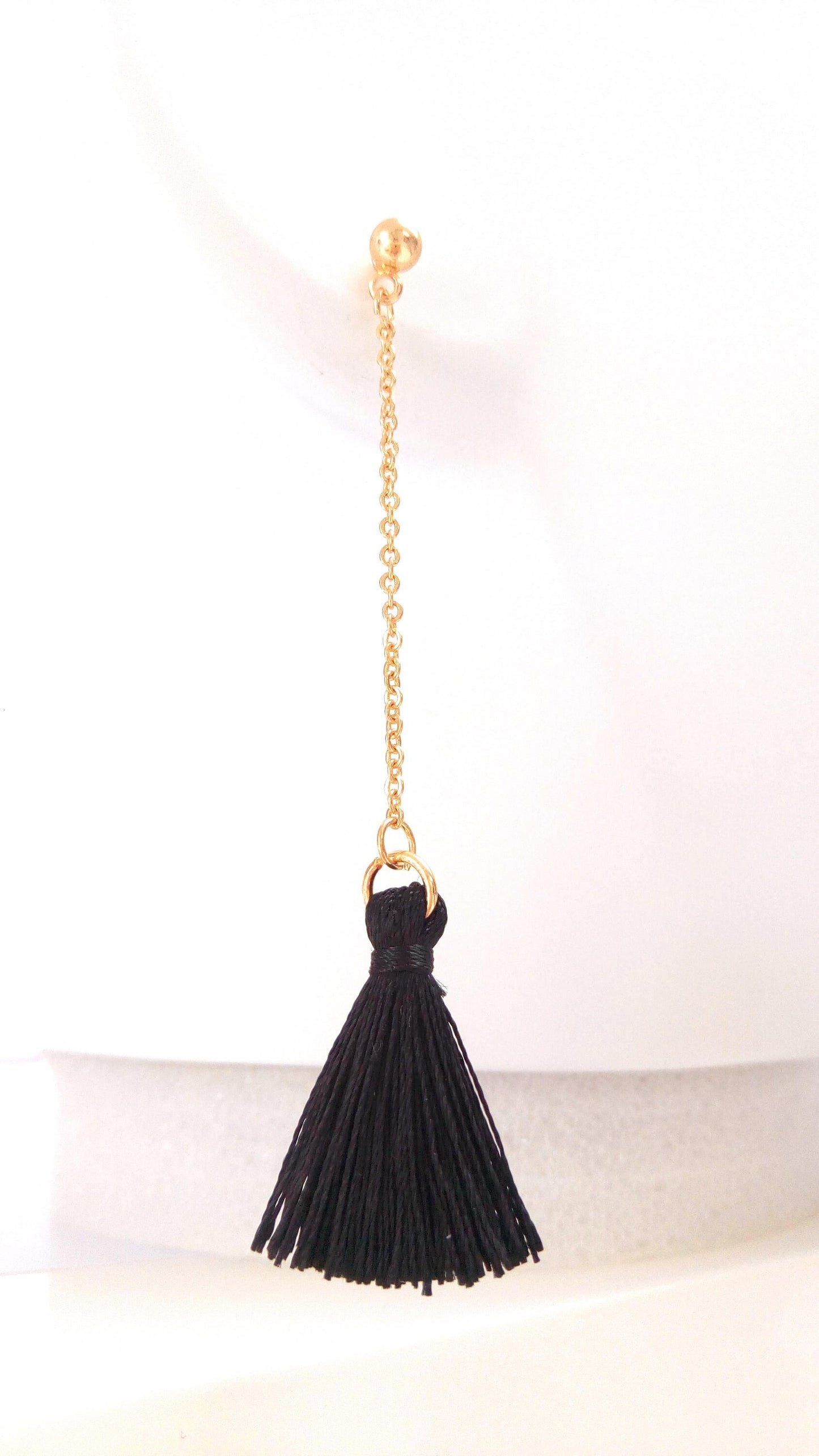Black pompom pendant earrings